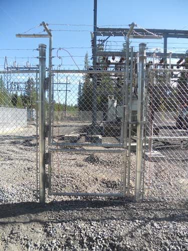 Chain link gate with barb wire, razor wire, and locks
