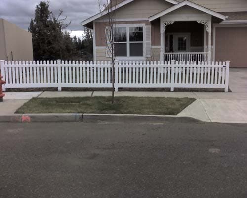 Vinyl picket fence in front of house