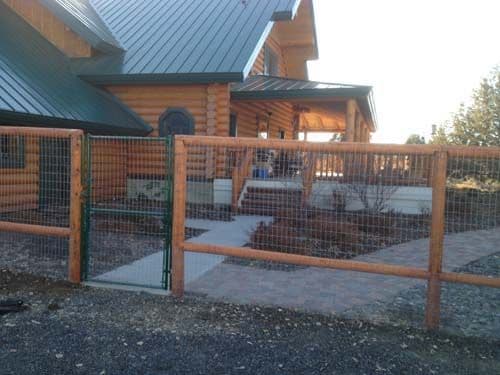 Custom ranch fencing with gate to match house