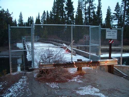 Chain link barrier in front of bridge