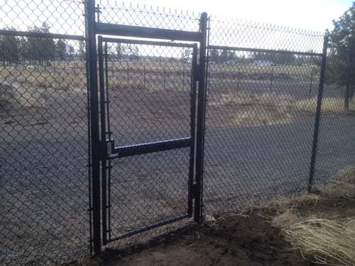 Chain link security fence and locked gate